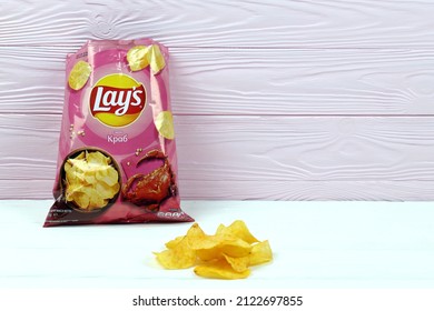 KHARKOV, UKRAINE - JANUARY 3, 2021: Lays potato chips with crab flavour and original lays logo in middle of package. Worldwide famous brand of potato crisps
