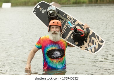 Kharkov, Ukraine - June 15, 2020. Bearded senior man with wakeboard.
