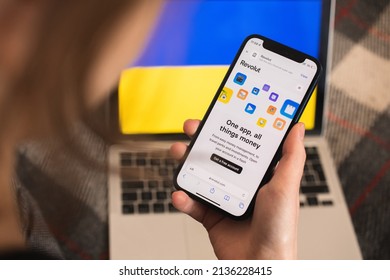 Kharkov, Ukraine - March 16, 2022: Girl Using Revolut In Ukraine With Debit Card On Mobile Phone. Revolut Logo, Europe Online Banking System Background Photo