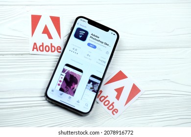 KHARKOV, UKRAINE - MARCH 5, 2021: Adobe Photoshop Icon And Application From App Store On IPhone 12 Pro Display Screen On White Wooden Table