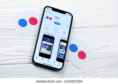 KHARKOV, UKRAINE - MARCH 5, 2021: Flickr icon and application from App store on iPhone 12 pro display screen on white wooden table