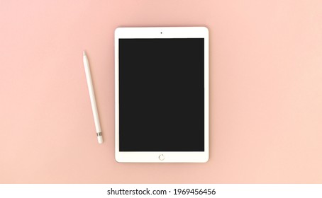 Kharkov, Ukraine - May 5, 2021: Digital Tablet Apple IPad With Pencil On Bright Peach Background, Mockup Or Template 