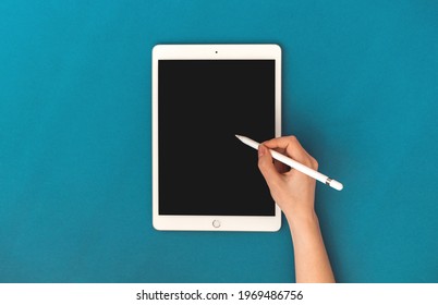 Kharkov, Ukraine - May 5, 2021: Woman Using Apple IPad Mockup With Pencil Stylus Pen, Colorful Background And Top View 