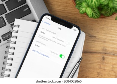 Kharkov, Ukraine - November 21, 2021: VPN Settings Screen On Apple IPhone. Business Workspace, Wooden Table, Top View