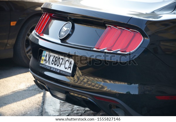 KHARKOV, UKRAINE - OCTOBER 20,\
2019: Black 2015 Ford Mustang 50 Year Limited Edition rear view\
outdoors