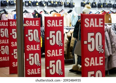 Kharkov,Ukraine-December 17 2021 Season sale, black friday and shopping concept. Red stand 50 percent discount price in shop. Clothes hangers on background.                                - Shutterstock ID 2092484935