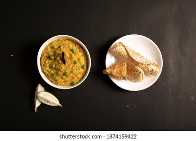 Khichdi Or Khichri Garnish With Pea Served With Papadum Or Papad