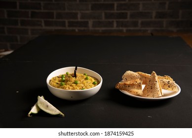 Khichdi Or Khichri Garnish With Pea Served With Papadum Or Papad