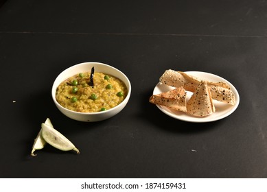 Khichdi Or Khichri Garnish With Pea Served With Papadum Or Papad