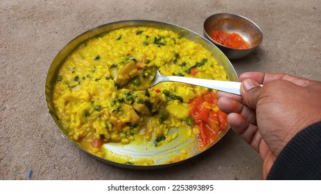 Khichdi is a popular Indian dish prepared by boiling lentils and rice together.This is especially useful for patients. Khichdi or normal khichdi Rice Urad black pulses with peel Lentils Salt Bhedadi  - Shutterstock ID 2253893895