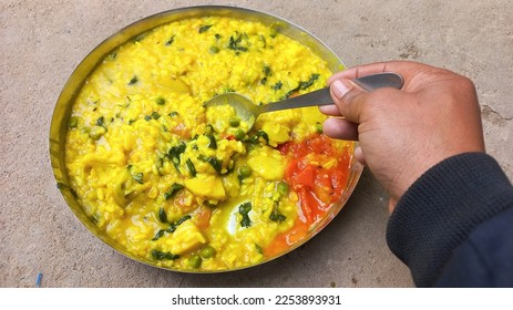 Khichdi is a popular Indian dish prepared by boiling lentils and rice together.This is especially useful for patients. Khichdi or normal khichdi Rice Urad black pulses with peel Lentils Salt Bhedadi  - Shutterstock ID 2253893931
