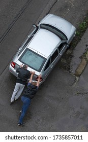 Khimki, Russia - May 05, 2020: Two Men Pushing A Car Stuck In A Ditch