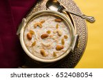 Khir or kheer payasam also known as Sheer Khurma Seviyan consumed especially on Eid or any other festival in india/asia. Served with dry fruits toppings in a bowl over colourful/wooden background. 