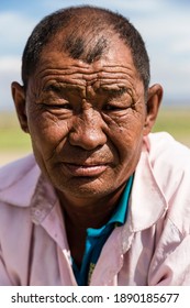 Khongoryn Els, Mongolia - 07 15 15: Facial Portrait Of A Relaxed Mongolian Man With A Furrowed Brow Outdoors In The Gobi Desert Of Mongolia