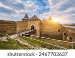 Khotyn fortress built in the 14th century. View of top of the fortress wall and towers among the hills closeup on background of Dniester river and its left bank at early springtime, Ukraine
