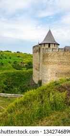Khotyninskaya fortress on the rocky slopes of the Dniester River in Ukraine. A bright sunny day surrounded by greenery. - Shutterstock ID 1342746890