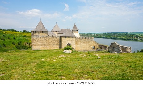 Khotyninskaya fortress on the rocky slopes of the Dniester River in Ukraine. A bright sunny day surrounded by greenery. - Shutterstock ID 1342746893