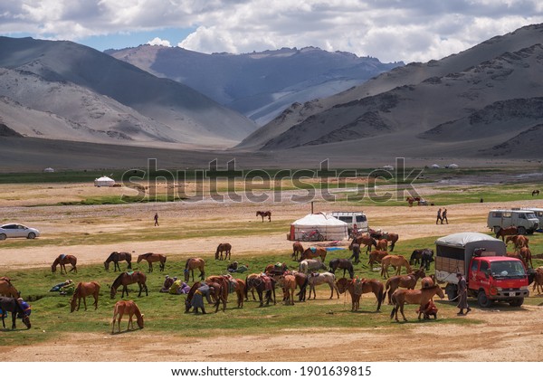 KHOVD, MONGOLIA - JULY 06, 2017: Mongolian\
nomad camp. Guests came to the national holiday and national\
wrestling competitions.
