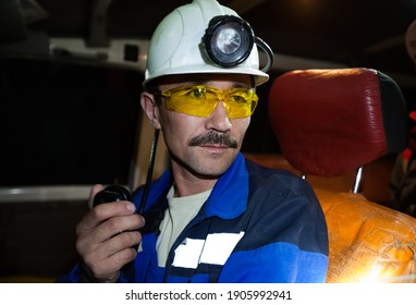 Khromtau, Aktobe Region, Kazakhstan - May 06 2012: Gold Ore Mining. Mine Truck Driver. Adult Asian Man In White Hardhat With Headlight And Yellow Protective Glasses.