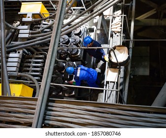 KhromtauKazakhstan - May 06 2012: Copper ore concentration plant. Maintenance workers and equipment.