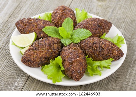 Kibbeh - Middle Eastern minced meat and bulghur wheat fried snack. Also popular party dish in Brazil (kibe).  [[stock_photo]] © 