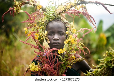 KIBISH, ETHIOPIA - AUGUST 22, 2018: unidentified woman from Surmi tribe, with  natural decorations of leave and flowers in a wreath. Surmi are also called Suri or Surma