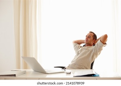 Kick Back In-between Deadlines. Businessman At Work Taking A Minute To Break Away From His Tasks.