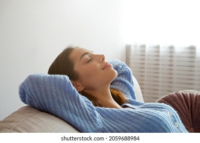 Kick Back And Relax Concept. Young Beautiful Brunette Woman With Eyes Closed And Blissful Facial Expression Alone On The Couch. Portrait Of Relaxed Female Resting At Home.