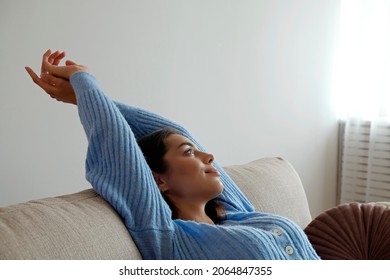 Kick Back And Relax Concept. Young Beautiful Brunette Woman With Eyes Closed And Blissful Facial Expression Alone On The Couch. Portrait Of Relaxed Female Resting At Home.