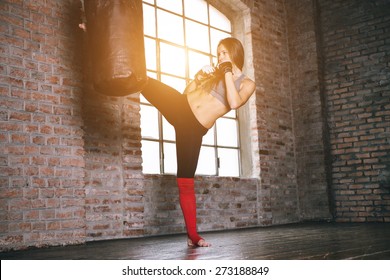 Kick At The Heavy Bag. Woman Making Kickboxing Training At The Heavy Bag