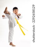 Kick. kids karate martial arts. Taekwondo uniform with yellow belt. Asian school boy isolated on white background banner