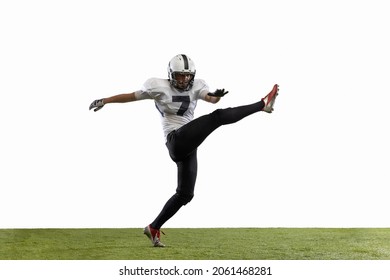 Kick. Portrait of American football player training isolated on white studio background with grass covering. Concept of sport, movement, achievements. Copy space for ad - Powered by Shutterstock