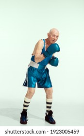 Kick. Senior Man Wearing Sportwear Boxing On Studio Background. Caucasian Male Model In Great Shape Stays Active And Sportive. Concept Of Sport, Activity, Movement, Wellbeing. Copyspace, Ad.