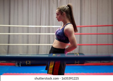 Kickbox fighter girl stretching before training