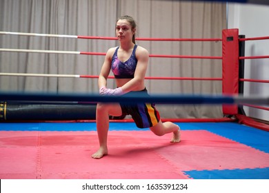 Kickbox fighter girl stretching before training