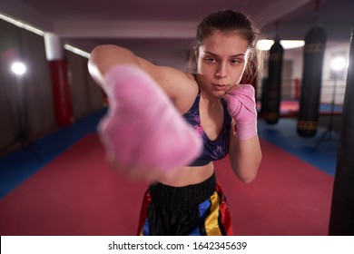 Kickboxer girl shadow boxing and kicking