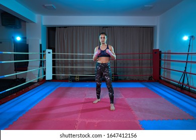 Kickboxer girl shadow boxing in the ring before sparring
