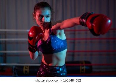 Kickboxer girl training in the ring