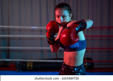 Kickboxer girl training in the ring
