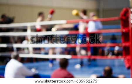 Kickboxing bout theme creative abstract blur background with bokeh effect. Not sharp picture as a background, wallpaper sport battle kickboxers in the ring