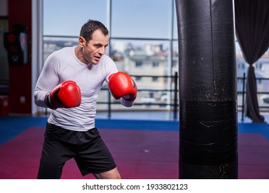 Kickboxing Fighter Hitting The Heavy Bag In The Gym, Training For Competition