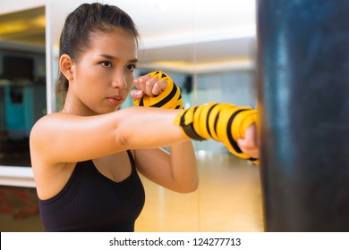 Kickboxing Girl Practicing With A Punching Bag