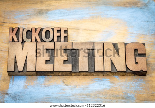 Kickoff meeting word\
abstract in letterpress wood type printing blocks against grunge\
wooden surface