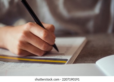 Kid Affected By Dyslexia Doing Homework, Writing, Reading Notebook Task Using Colorful Overlay Strip. Education, Learning Disability, Reading Difficulties Concept