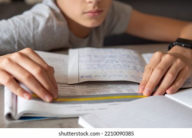 Kid affected by dyslexia doing homework, writing, reading notebook task using colorful overlay strip. Education, learning disability, reading difficulties concept - Shutterstock ID 2210090385