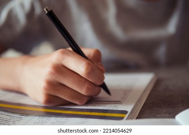 Kid Affected By Dyslexia Doing Homework, Writing, Reading Notebook Task Using Colorful Overlay Strip. Education, Learning Disability, Reading Difficulties Concept