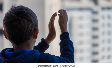 Kid Applauding From Balcony To Support Medical Staff, Health Workers, Doctors, Nurses During Coronavirus Pandemic