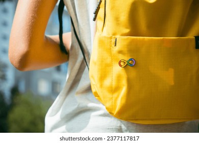 Kid with backpack with autism infinity rainbow symbol sign. World autism awareness day, autism rights movement, neurodiversity, autistic acceptance movement - Powered by Shutterstock