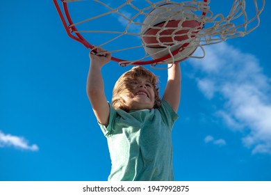 Kid Basketball Player Makes Slam Dunk. Active Kids Enjoying Outdoor Game With Basketball