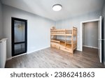 Kid bedroom with parquet floor, child house bed, white walls and open door. Modern child room with wooden bunk bed and elegant minimalist interior design.